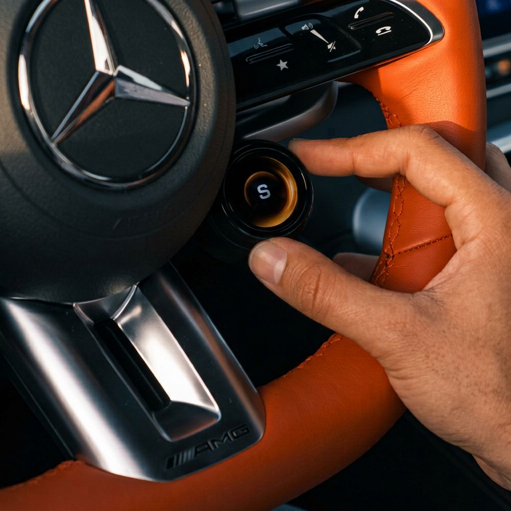 Hand on a Mercedes-AMG steering wheel drive-mode dial – polished automotive video content